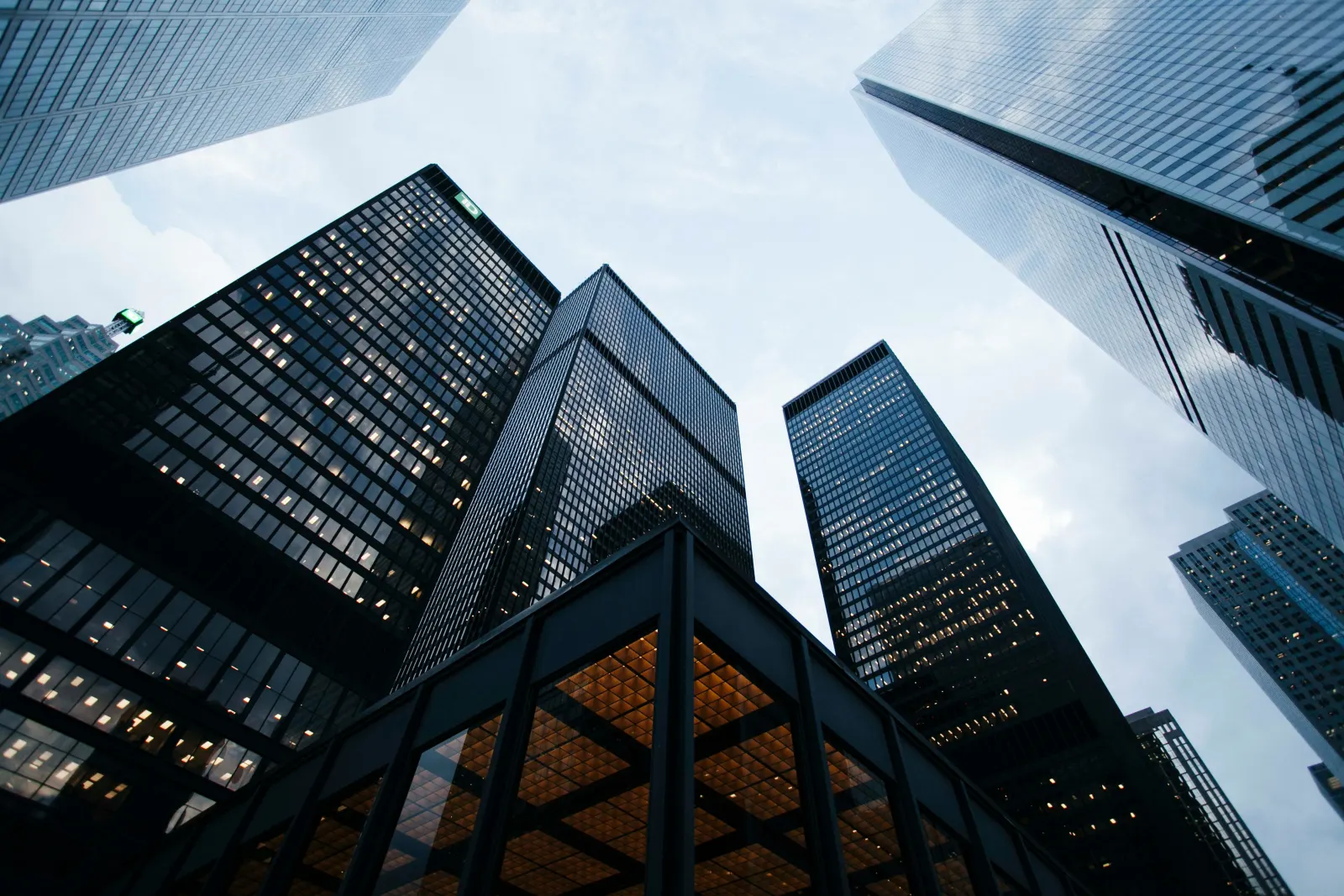 Glass office towers seen from street level, looking up